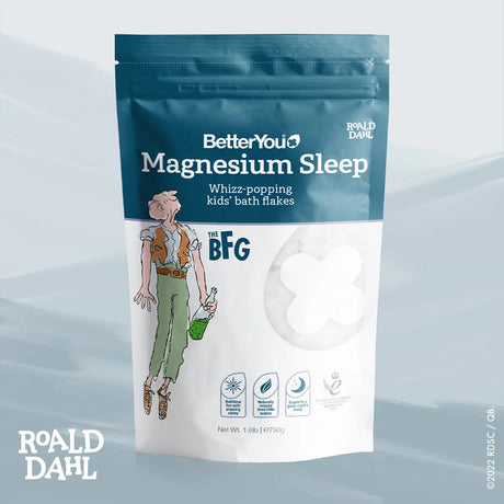 Package of BetterYou Magnesium Sleep bath flakes with Roald Dahl branding on a light blue gradient background